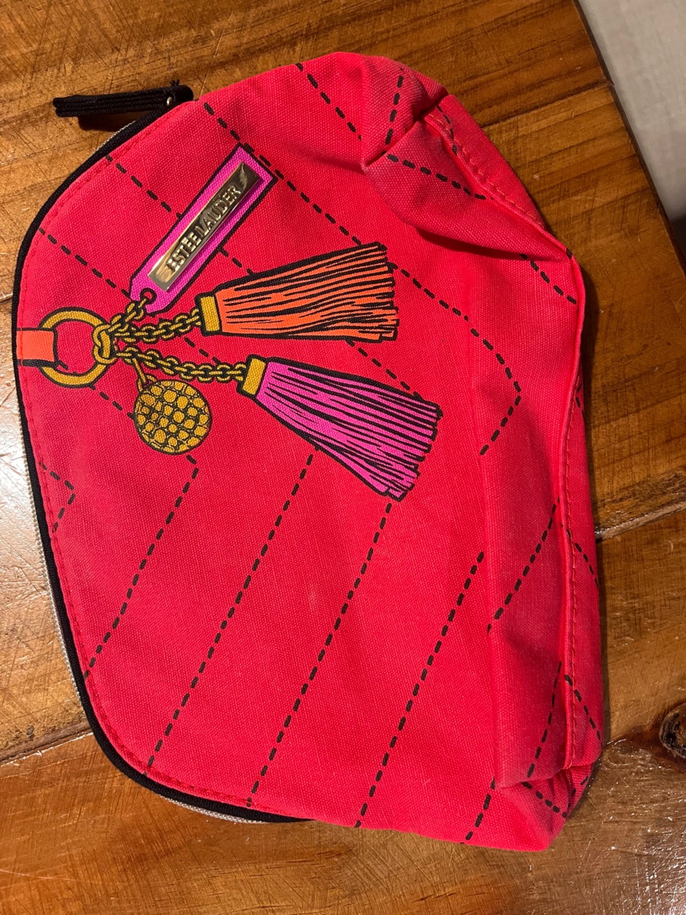 Estee Lauder red cosmetic pouch with pink and orange tassel print